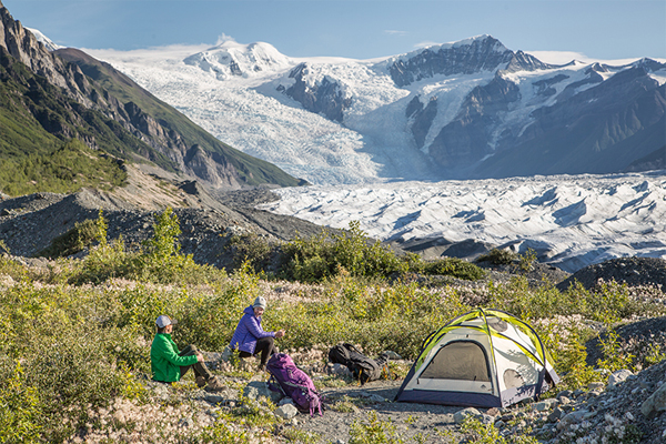 Women camp near a glacier in Wrangell-St. Elias National Park and Preserve, an area which contains nearly ten million acres of designated wilderness, and has a array of connections to, and differing meanings for, many groups of people.